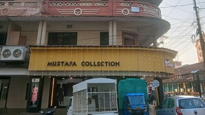 A building with a sign for 'Vihasta Collection' and 'Mustafa Collection'. - Vihasta Sunrise Hotel by RR Enterprises (Margao)