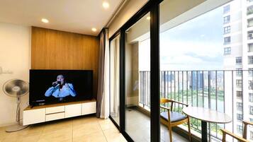 Apartment, 3 Bedrooms | Living area | 50-inch TV with cable channels