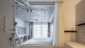 A modern bathroom with a shower, a mirror, and a sink.