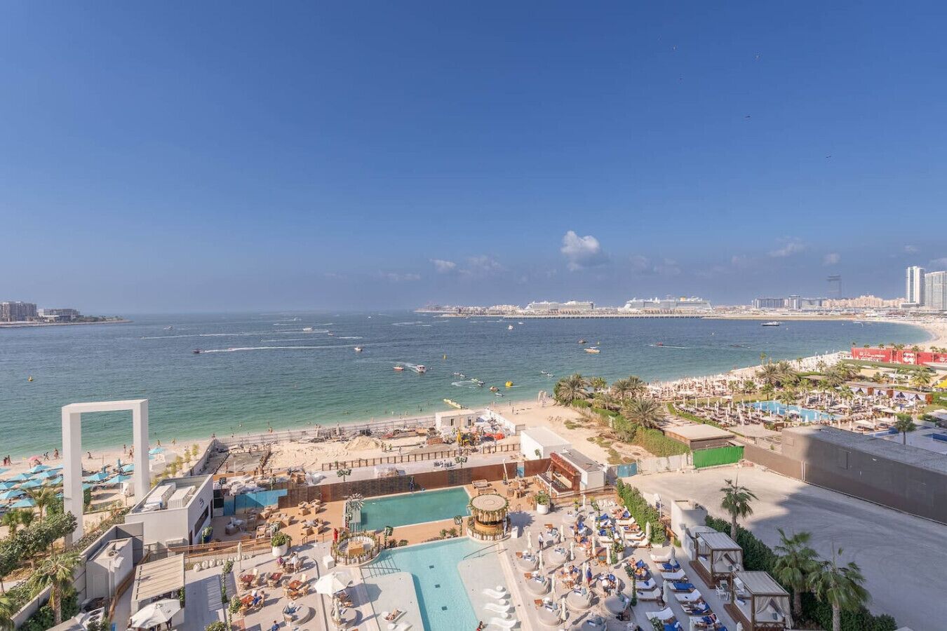 A resort with a pool, beach, and ocean view.
