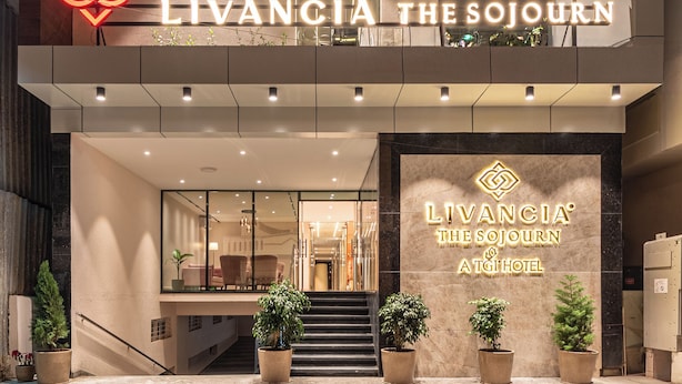 A modern hotel entrance with a prominent sign for "Livancia The Sojourn" and "ATG Hotel".