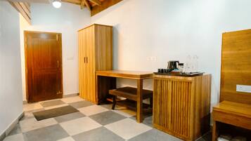 A room with a checkered floor, wooden furniture, and a ceiling with exposed beams.