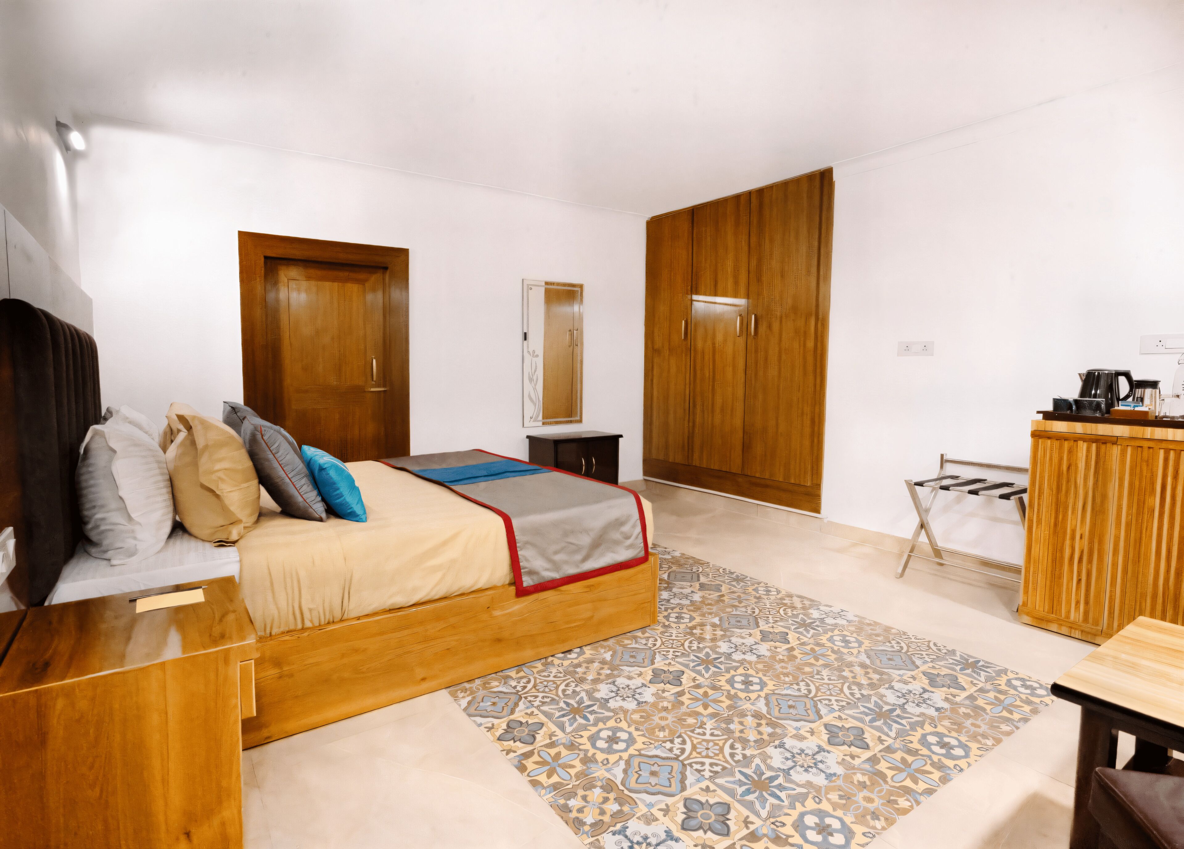 A modern bedroom with a wooden bed, a small desk, and a wardrobe.