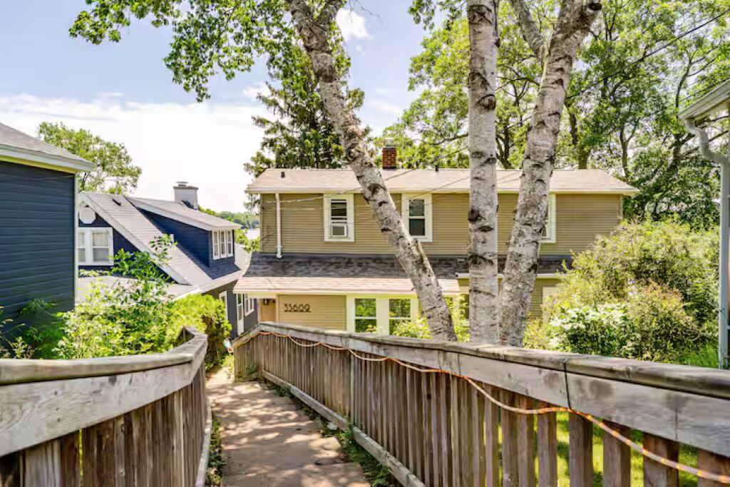 A wooden pathway leading to a house with a number 33602 on the door.