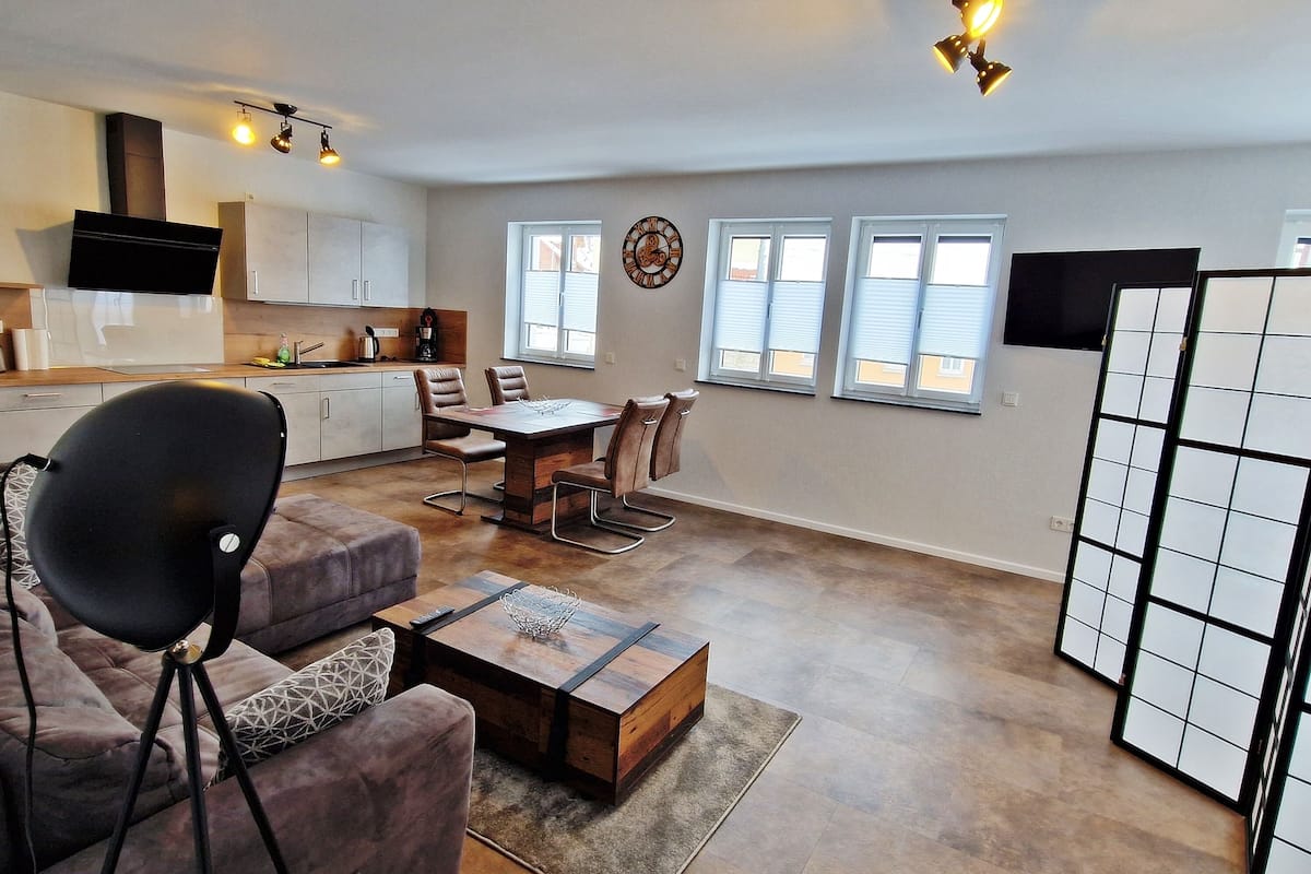 Deluxe Apartment | Living area | 50-inch Smart TV with satellite channels, heated floors