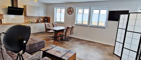 Deluxe Apartment | Living area | 50-inch Smart TV with satellite channels, heated floors
