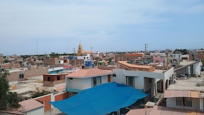 A residential area with various buildings, including a prominent yellow church with a bell tower.