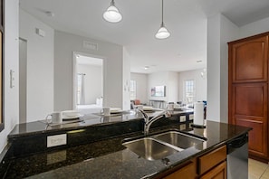 - Sleek granite countertops with a double sink and modern fixtures for all your culinary needs
- Open-concept design, offering views into the living & dining areas while you cook
- Spacious, ensuring a comfortable & functional workspace for meal pre