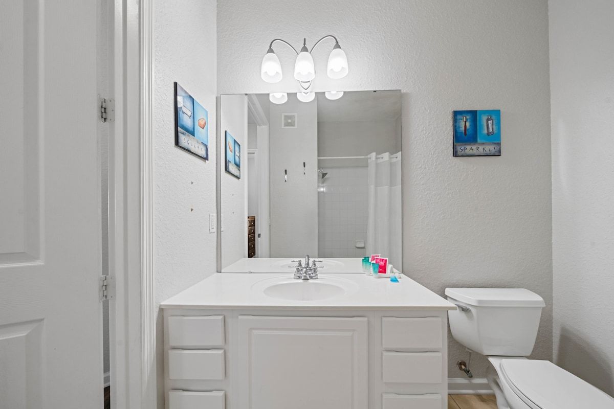 - Start your day fresh in this well-lit bathroom with a large mirror and plenty of counter space
- Spotless and equipped with all the essentials for a stress-free stay
- Thoughtful touches, like wall art and clean design, make it feel like home