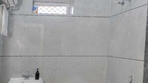 A bathroom with a toilet, sink, and shower. - Shree Ji Kunj (Udaipur)