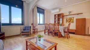 A spacious living room with a dining area, large windows, and a modern kitchen. - Beachfront Apartment With Terrace Views (Roses)