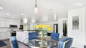 A modern kitchen with white cabinets, a microwave, and a stove. - Modern 3bed, 2bath House in Wesley Chapel, with EV Charging Outlet, AC, & WiFi.  (Zephyrhills)