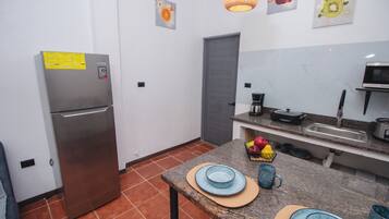 Fridge, microwave, coffee/tea maker, cookware/dishes/utensils
