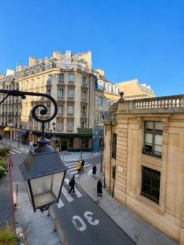 A street view with a building featuring a large window and a street lamp.