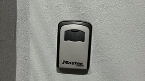 A Master Lock on a white wall. - Molinos House 3 (Santa Isabel)
