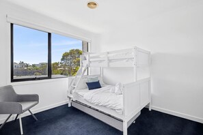 A bunk bed with a view of the outdoors through a window. - Magic Driftwood (Torquay)