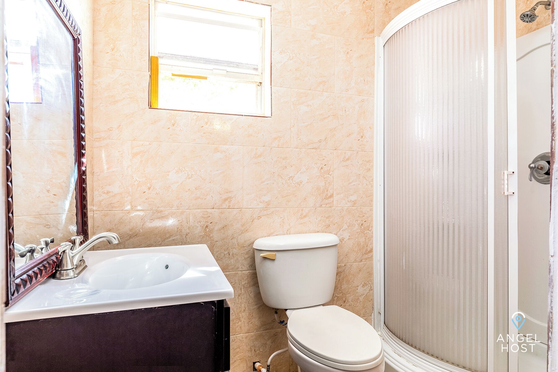 A bathroom with a sink, toilet, and shower.