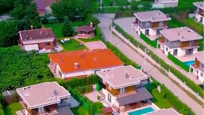 An aerial view of a residential area with multiple two-story houses, each with a swimming pool. - MERAL RESORT 1 (Sapanca)