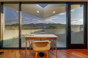 Enjoy scenic views from the balcony with a dining table and chair.