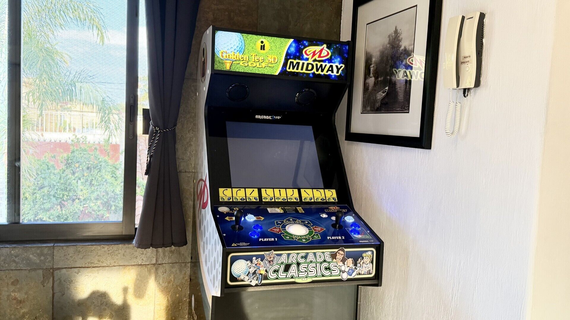 An arcade machine with a screen displaying a golf game, labeled 'Golden Tee 3D Golf,' and 'Midway' branding.