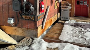 A wooden building with a red door, a fire extinguisher, and a welcome sign. - True Adirondack Retreat! Nestled in the Mountains! (Mayfield)