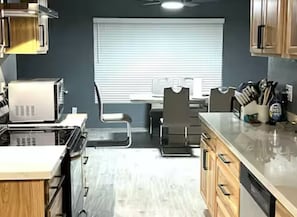 Enjoy cooking in this well-equipped kitchen with a central island, microwave, oven, and coffee maker.