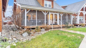 A two-story house with a covered porch, a stone pathway, and a grassy yard. - Dover Dreamin’ – Lake Life starts here! 3BD, 3BA Retreat, Steps from the Water (Dover)