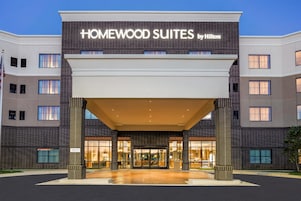 Entrada de un hotel con un cartel que dice 'Homewood Suites by Hilton'.