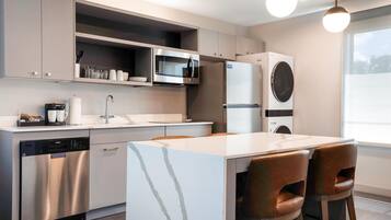 A modern kitchen with stainless steel appliances, a dishwasher, and a built-in oven.