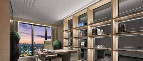 A modern office space with a large desk, shelving units, and a view of the cityscape through large windows.