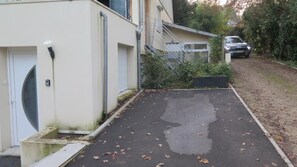 Guests can park their car in the driveway leading to this two-story home with a garage.