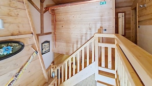 Un intérieur en bois avec un escalier, des murs en bois et une enseigne indiquant « des Alpes ».