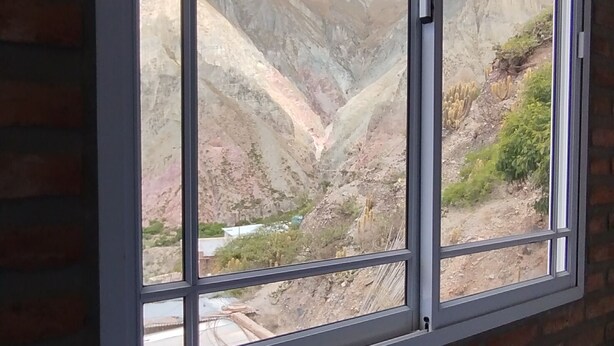 Une pièce dotée d’une grande fenêtre donnant sur un paysage montagneux.