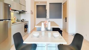 A modern kitchen with a dining area.