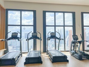 Work out with a city view at this fitness room featuring exercise bikes and treadmills.