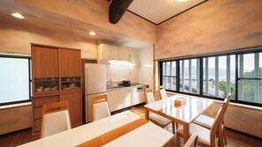 Enjoy meals in the kitchen with a central island and adjacent dining area, offering a view of the surrounding landscape.