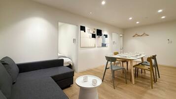 Superior Apartment | Living area | 55-inch Smart TV with cable channels