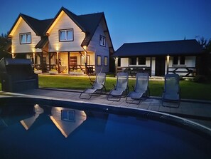A two-story house with a swimming pool and lounge chairs. - Comfortable Holiday Homes, Swimming Pool, Rewal (Rewal)