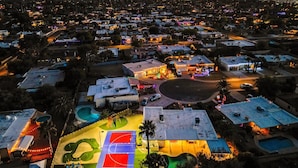 An aerial view of a residential area with houses, a basketball court, and a swimming pool. - Rio Resort (Scottsdale)
