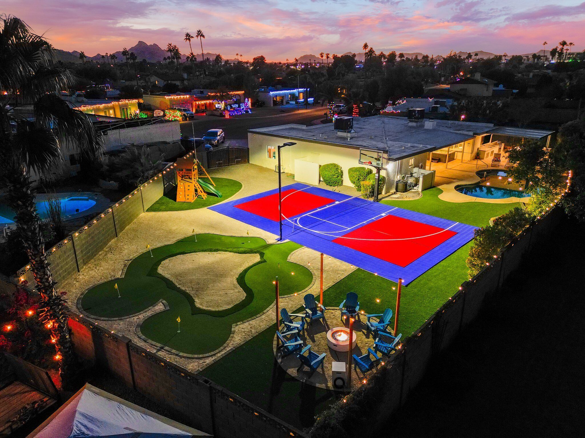 A residential area with a basketball court, a swimming pool, and a children's play area.