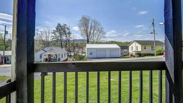 A residential area with houses, a garage, and a grassy lawn.