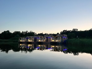 A floating structure with multiple levels, connected by walkways, over a calm body of water. - Luxury Houseboat for 2 People, by the sea (gmina Sianów)