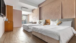 A hotel room with two beds, a wooden wardrobe, a desk with a chair, and a large window. - 35.5 inn (Hengchun)
