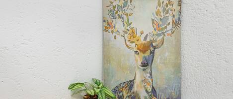 A painting of a deer with antlers on a wall.