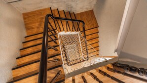A wooden staircase with a metal handrail and a metal basket at the top. - 35.5 inn (Hengchun)