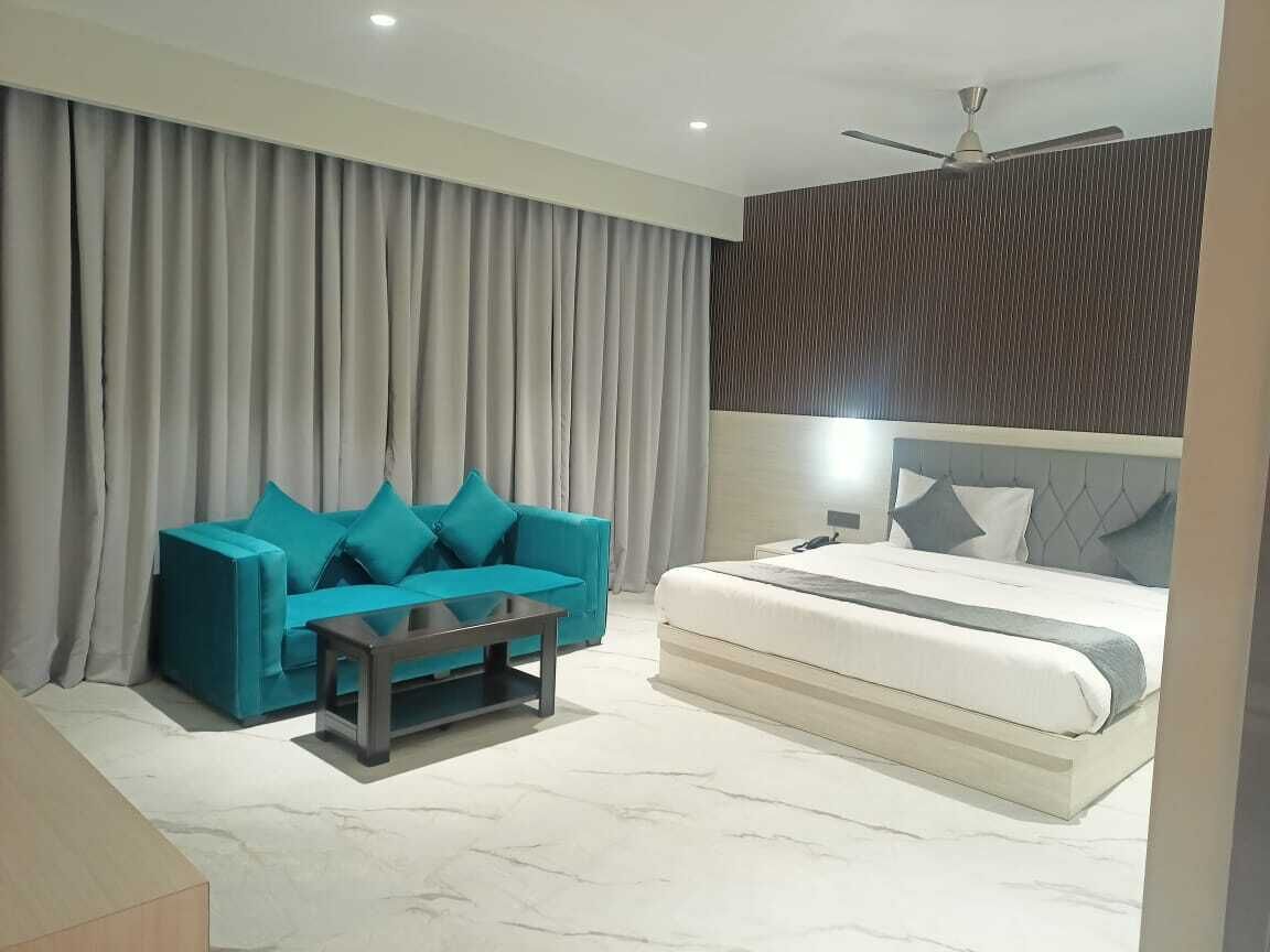 A modern bedroom with a bed, a sofa, and a coffee table.