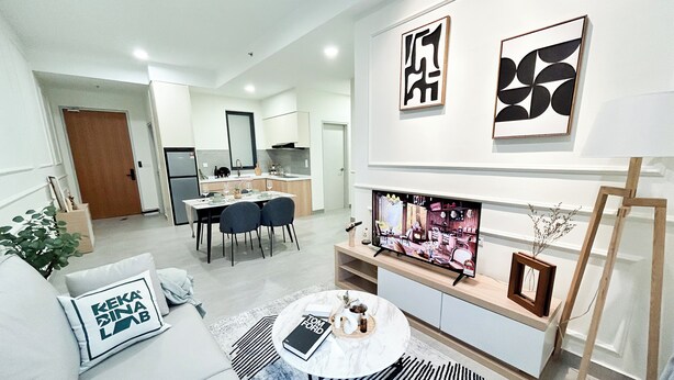 A modern living room with a sofa, coffee table, and artwork on the wall. - Sunsuria Forum by Manhattan Group  (Shah Alam)
