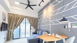 A modern living room with a dining area, a ceiling fan, and a geometric wall design. - The Luxe by Manhattan Group  (Kuala Lumpur)