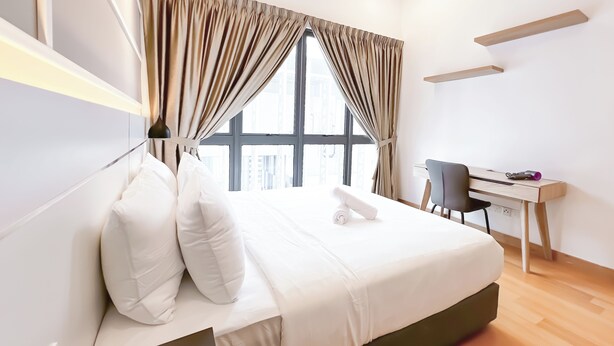 A modern hotel room with a large bed, a desk, and a view of the city. - The Luxe by Manhattan Group  (Kuala Lumpur)