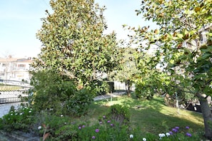 Escape to a serene garden oasis with lush greenery and a variety of flowering plants.